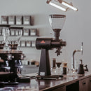 Mahlkonig EK43 98mm flat burr shop grinder in a lifestyle setting